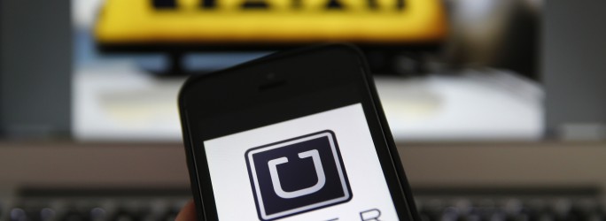 An illustration picture shows the logo of car-sharing service app Uber on a smartphone next to the picture of an official German taxi sign in Frankfurt, September 15, 2014. A Frankfurt high court will hold a hearing on a recent lawsuit brought against Uberpop by Taxi Deutschland on Tuesday.  San Francisco-based Uber, which allows users to summon taxi-like services on their smartphones, offers two main services, Uber, its classic low-cost, limousine pick-up service, and Uberpop, a newer ride-sharing service, which connects private drivers to passengers - an established practice in Germany that nonetheless operates in a legal grey area of rules governing commercial transportation. The company has faced regulatory scrutiny and court injunctions from its early days, even as it has expanded rapidly into roughly 150 cities around the world.   REUTERS/Kai Pfaffenbach (GERMANY - Tags: BUSINESS EMPLOYMENT CRIME LAW TRANSPORT)