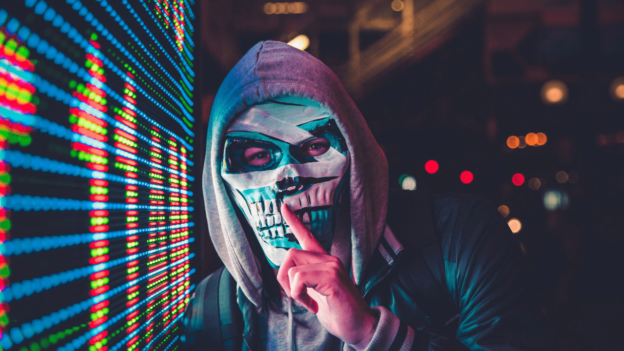 Hacker mascarado pedindo silêncio (Imagem: Max Bender/Unsplash) 