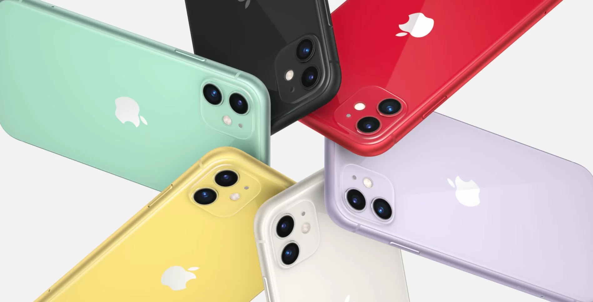 Celulares iPhone um ao lado do outro, nas cores preta, vermelha, lilás, branca, amarela e verde